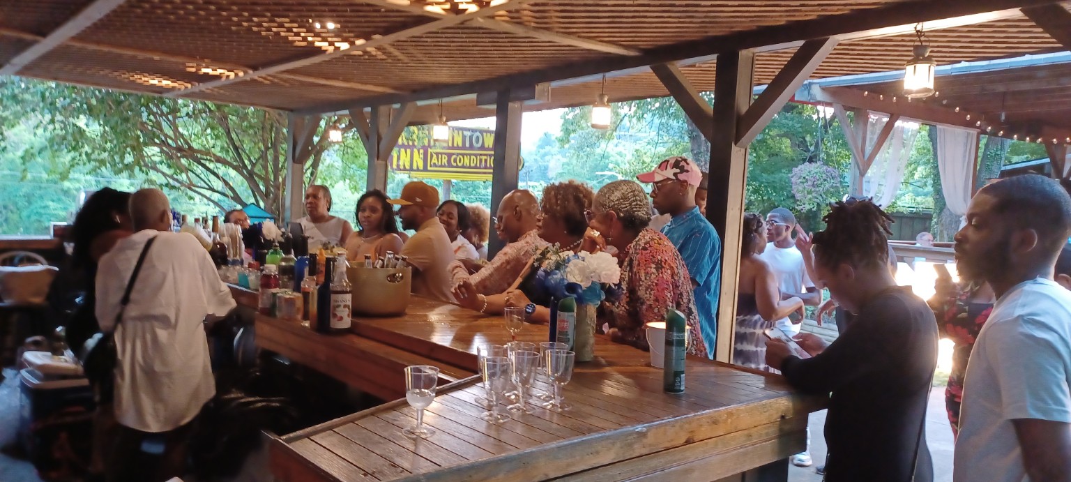 Guests gathering at the outdoor garden bar