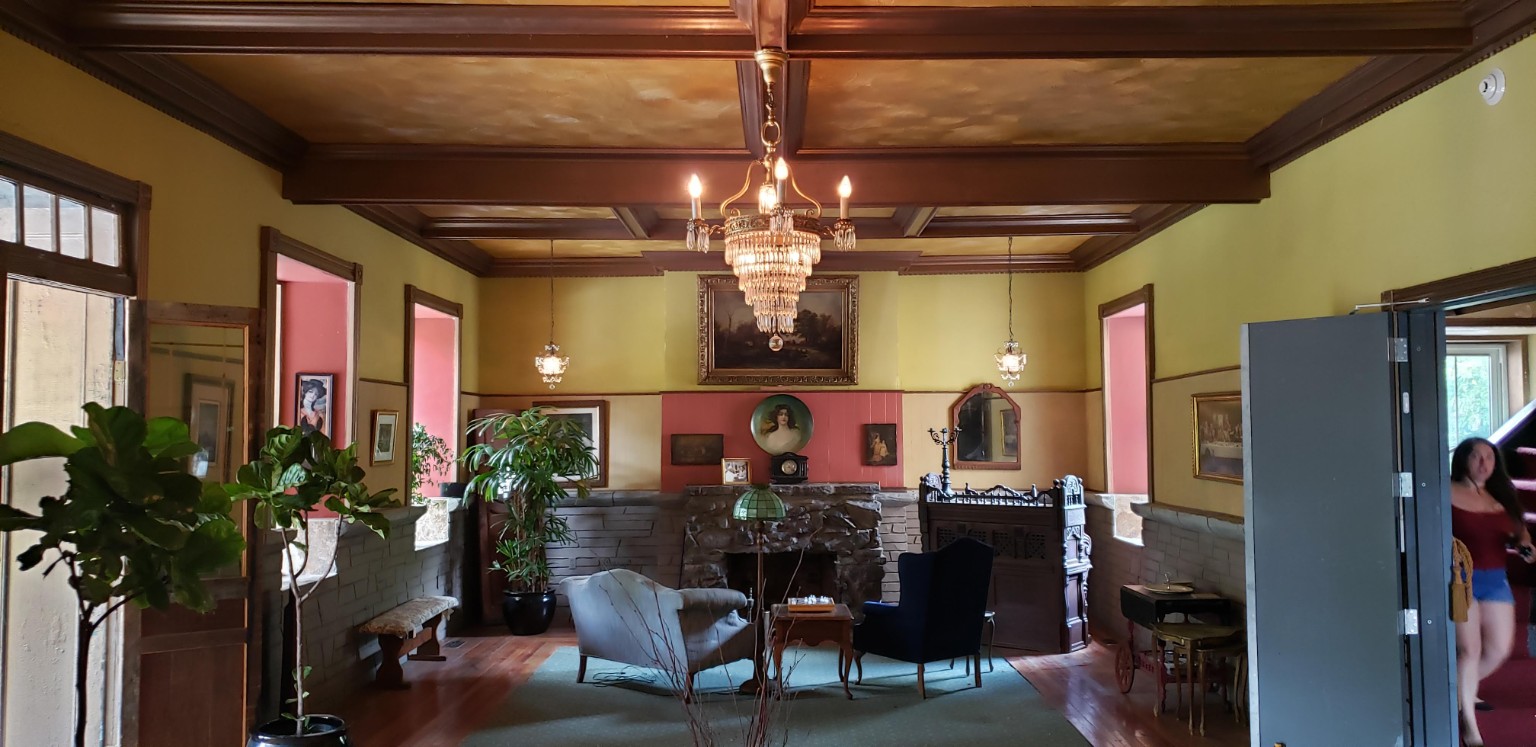 Historic interior room with fireplace and chandelier